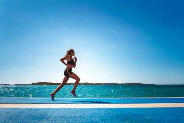 Woman running showing strong leg muscle Paisley